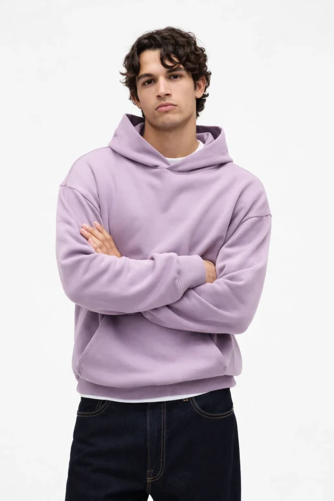 A minimalist studio image featuring a unisex lavender pullover hoodie with a clean, modern silhouette. Designed with a soft fleece interior, structured hood, ribbed cuffs, and hem, this hoodie offers a relaxed fit ideal for everyday wear. The muted lavender tone adds a contemporary, fashion-forward touch while maintaining versatility for casual and streetwear collections. Perfect for private label hoodie programs, this style highlights neutral branding potential, seasonal color drops, and gender-neutral appeal.
