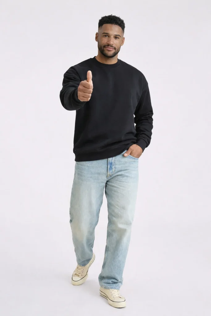 A clean studio-style image featuring a men’s black crewneck sweatshirt paired with light blue denim jeans. Designed with a relaxed, modern fit, this sweatshirt showcases a classic ribbed neckline, cuffs, and hem for everyday wear. The minimal silhouette and versatile black color make it ideal for streetwear, casualwear, and private label apparel collections. Perfect for OEM/ODM manufacturing, this style suits brands focused on timeless basics, comfort-driven design, and effortless layering.